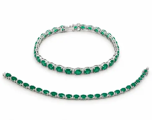[B4260E] 18CM WHITE GOLD RIVIERE BRACELET WITH DIAMONDS AND 10.62 CT TW EMERALDS.